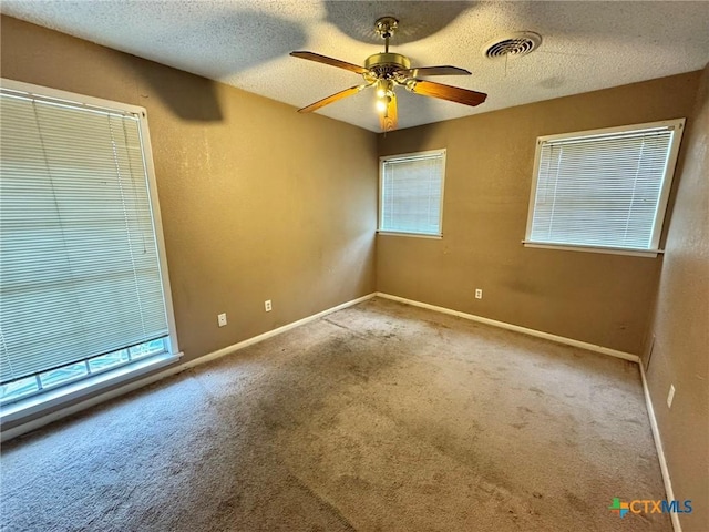 1804 Prather Dr, Killeen, TX 76541 - spare room featuring a healthy amount of sunlight, ceiling fan, carpet flooring, and visible vents