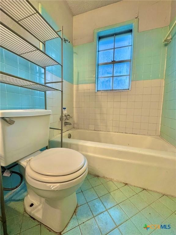 1804 Prather Dr, Killeen, TX 76541 - full bathroom with tile patterned flooring, bathtub / shower combination, toilet, and tile walls