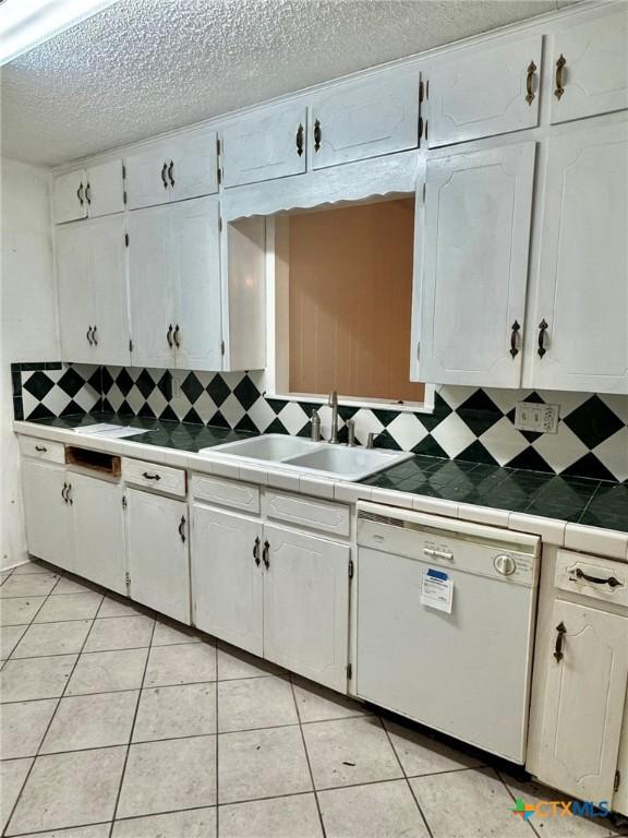1804 Prather Dr, Killeen, TX 76541 - kitchen featuring white cabinetry, a sink, and dishwasher