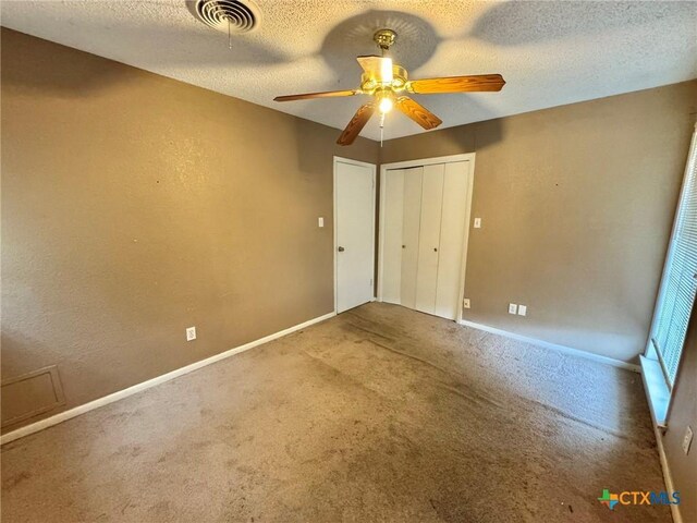 1804 Prather Dr, Killeen, TX 76541 - unfurnished bedroom with baseboards, carpet flooring, a textured ceiling, and visible vents