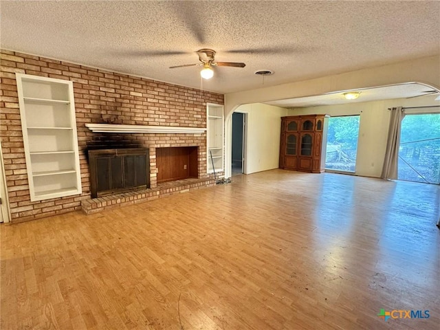 1804 Prather Dr, Killeen, TX 76541 - unfurnished living room featuring arched walkways, ceiling fan, and wood finished floors