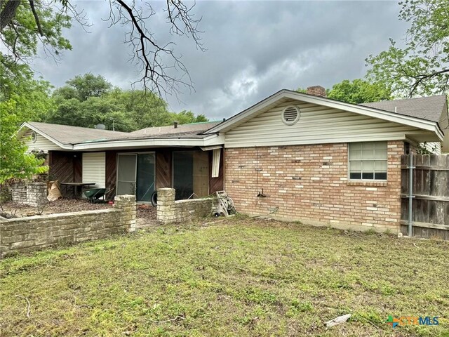 1804 Prather Dr, Killeen, TX 76541 - ranch-style house featuring fence, a chimney, brick siding, and a front yard