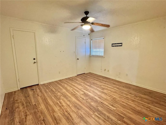 1804 Prather Dr, Killeen, TX 76541 - spare room with baseboards, ceiling fan, a textured ceiling, and wood finished floors