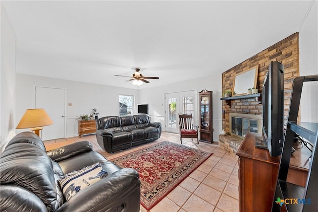 tiled living room with a fireplace and ceiling fan