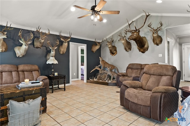 living room featuring ornamental molding, lofted ceiling, ceiling fan, and light tile patterned floors