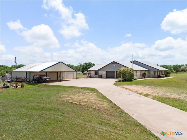 ranch-style house featuring a garage and a front yard