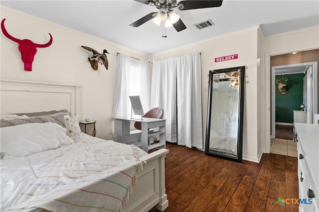 bedroom featuring ceiling fan, crown molding, and dark hardwood / wood-style flooring