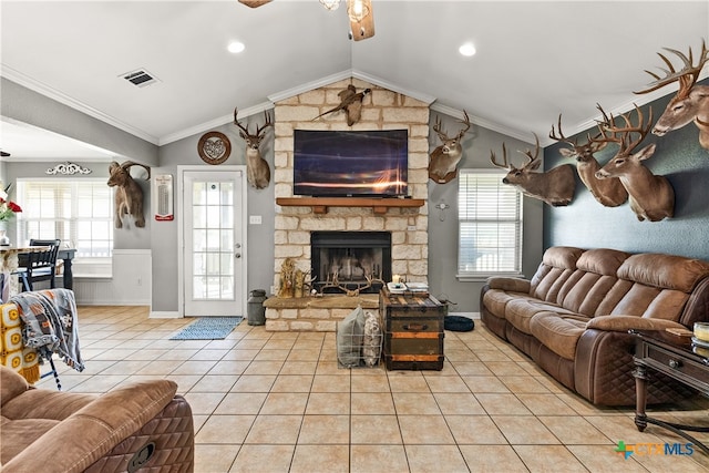 tiled living room with plenty of natural light, vaulted ceiling, and crown molding