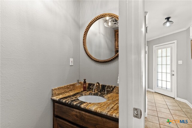 bathroom with vanity, tile patterned floors, and crown molding