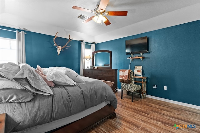 bedroom featuring wood-type flooring and ceiling fan