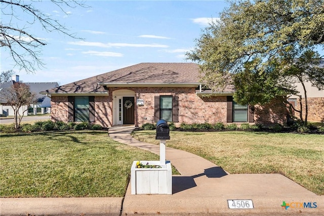 ranch-style home with a front lawn