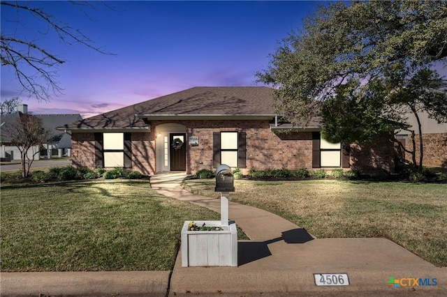 view of front of home with a lawn