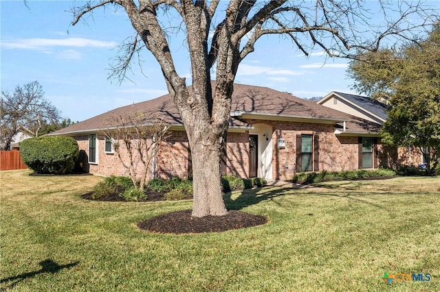 ranch-style home with a front lawn