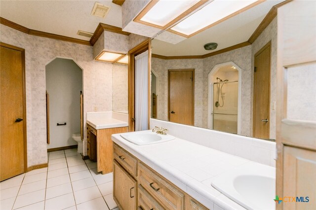 bathroom with ornamental molding, vanity, an enclosed shower, tile patterned floors, and toilet