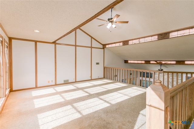 bonus room featuring ceiling fan, a textured ceiling, high vaulted ceiling, and light colored carpet