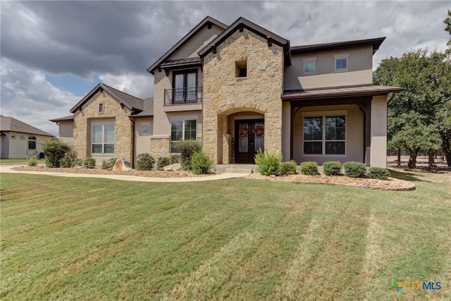 2326 Haven Bluff Ct, New Braunfels, TX 78132 - view of front of home with stone siding, a balcony, french doors, and a front lawn