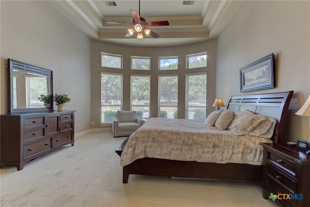 2326 Haven Bluff Ct, New Braunfels, TX 78132 - bedroom with ornamental molding, light carpet, a tray ceiling, a ceiling fan, and baseboards