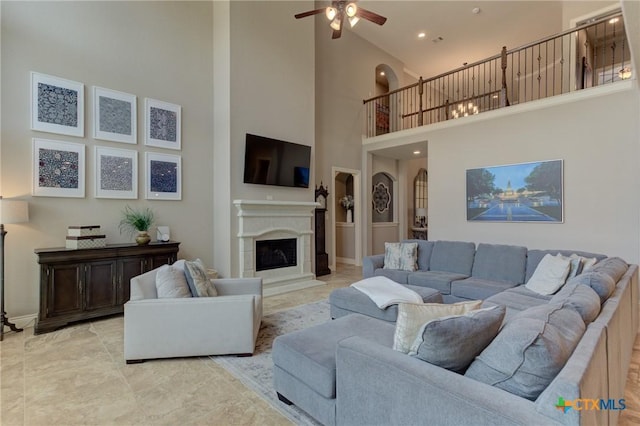 2326 Haven Bluff Ct, New Braunfels, TX 78132 - living room with a towering ceiling, a ceiling fan, a fireplace, and recessed lighting