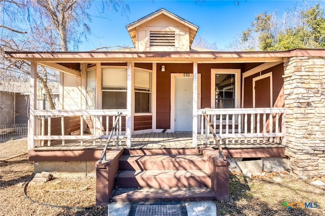 doorway to property featuring a porch