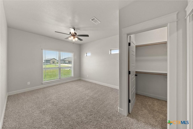 6119 Big Tree Dr, Salado, TX 76571 - unfurnished bedroom featuring carpet flooring, a walk in closet, and baseboards