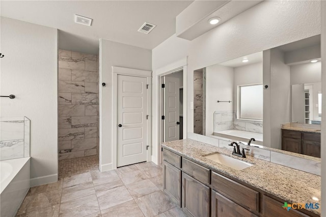 6119 Big Tree Dr, Salado, TX 76571 - full bathroom with a garden tub, marble finish floors, vanity, and tiled shower