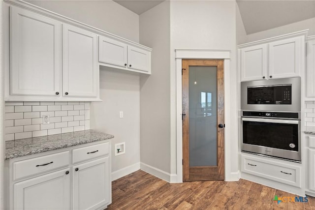 6119 Big Tree Dr, Salado, TX 76571 - kitchen featuring stainless steel appliances, tasteful backsplash, baseboards, white cabinets, and light stone counters
