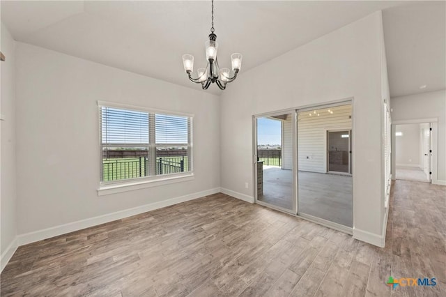 6119 Big Tree Dr, Salado, TX 76571 - spare room featuring a chandelier, wood finished floors, and baseboards