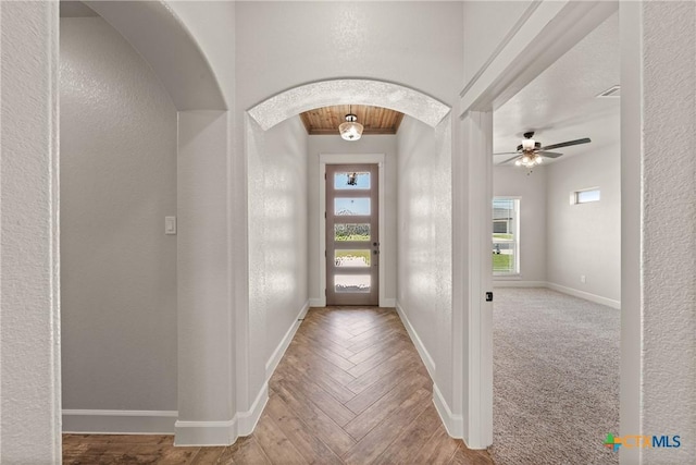 6119 Big Tree Dr, Salado, TX 76571 - entrance foyer with arched walkways, baseboards, a textured wall, a ceiling fan, and parquet floors