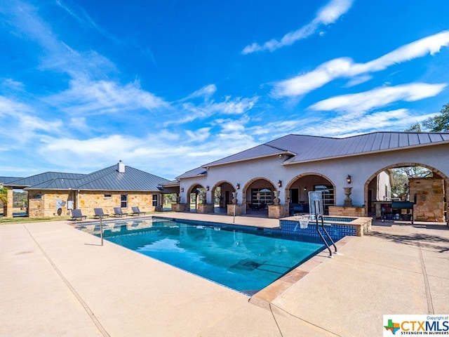 view of swimming pool with a patio