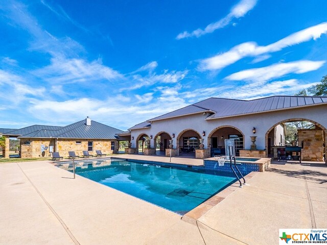 view of swimming pool with a patio