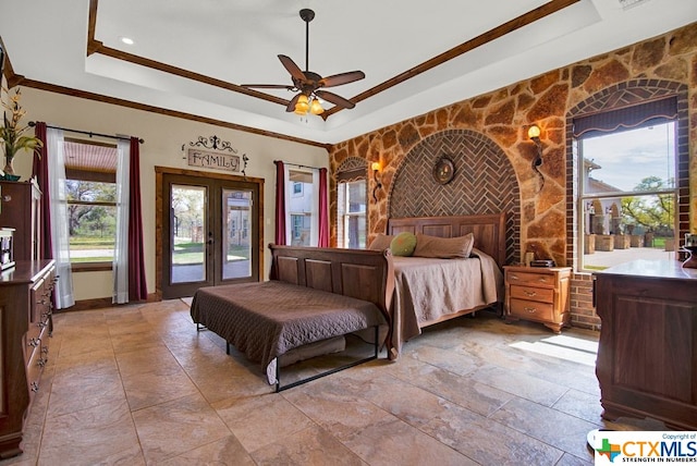 bedroom with ceiling fan, access to exterior, a raised ceiling, crown molding, and french doors