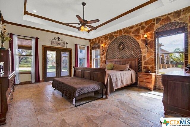 bedroom with ceiling fan, access to exterior, a raised ceiling, crown molding, and french doors