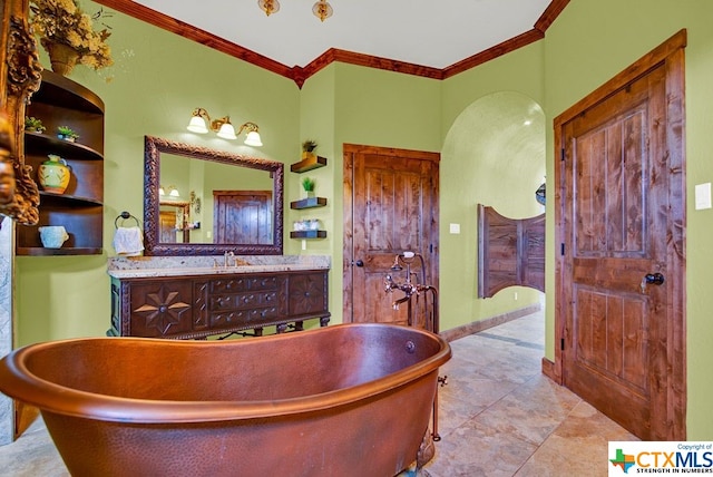 bathroom featuring vanity, tile patterned flooring, a washtub, and crown molding