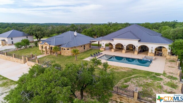 view of swimming pool featuring a yard and a patio area