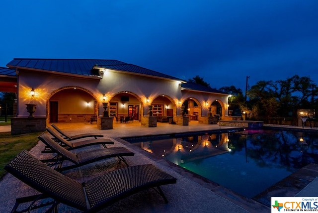 pool at night with a patio