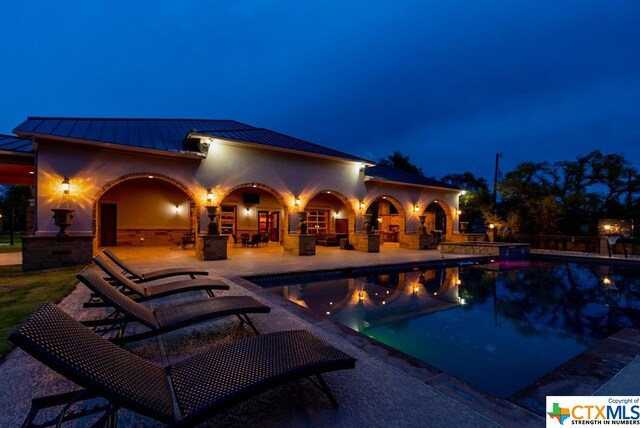 pool at night with a patio