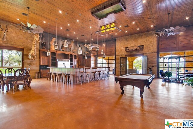 recreation room featuring wooden ceiling, a high ceiling, a healthy amount of sunlight, and billiards