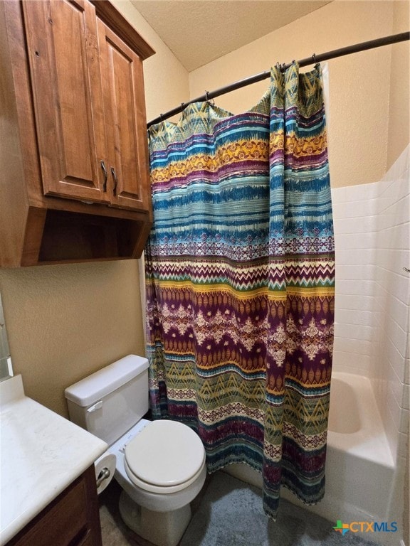 full bathroom with toilet, shower / bath combo, vanity, and a textured ceiling