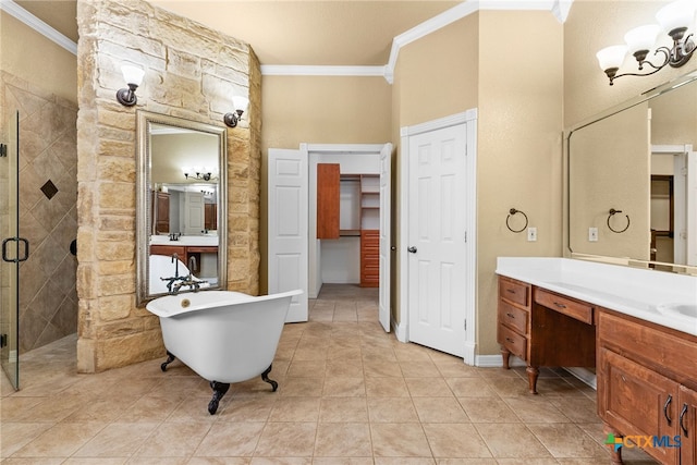 bathroom featuring a stall shower, ornamental molding, an inviting chandelier, a freestanding bath, and vanity