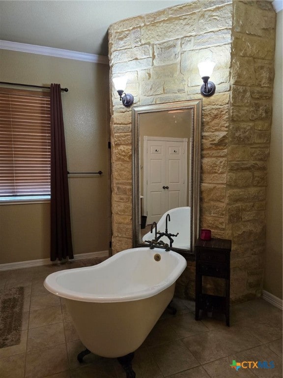 bathroom featuring a bath, tile patterned floors, and ornamental molding