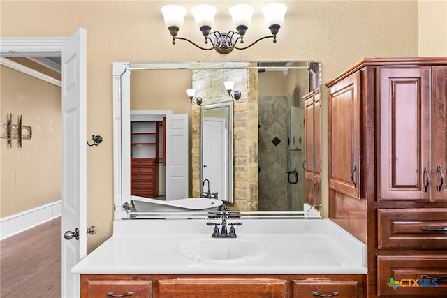 bathroom with a stall shower, wood finished floors, and vanity