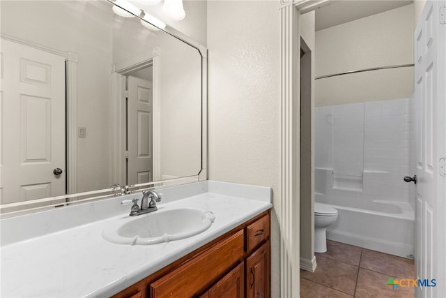 bathroom featuring tile patterned flooring, bathtub / shower combination, vanity, and toilet