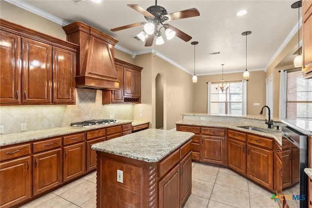 kitchen featuring custom range hood, a kitchen island, brown cabinets, appliances with stainless steel finishes, and a sink