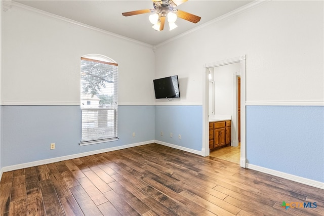 unfurnished room with a ceiling fan, baseboards, ornamental molding, and wood finished floors