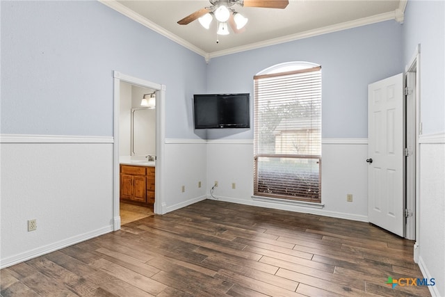 interior space with ornamental molding, dark wood-style flooring, a sink, and connected bathroom