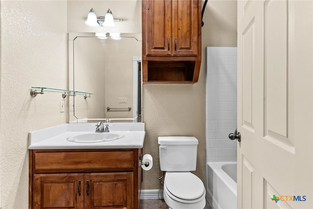 full bath with a textured wall, toilet, vanity, baseboards, and shower / washtub combination