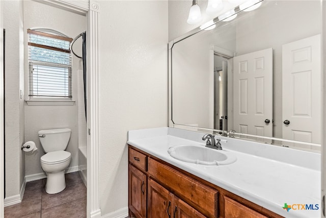 full bath featuring toilet, tile patterned flooring, baseboards, and vanity