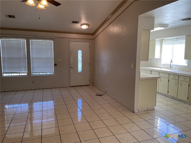 307 Hickok Ct, Austin, TX 78753 - foyer featuring light tile patterned floors, a ceiling fan, and ornamental molding