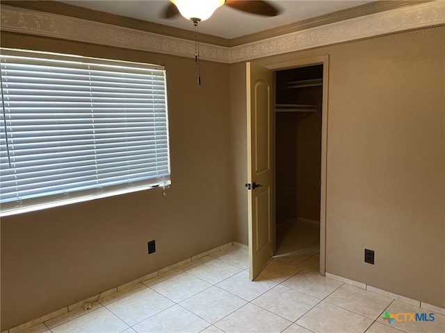 307 Hickok Ct, Austin, TX 78753 - unfurnished bedroom with ornamental molding, light tile patterned floors, baseboards, and multiple windows