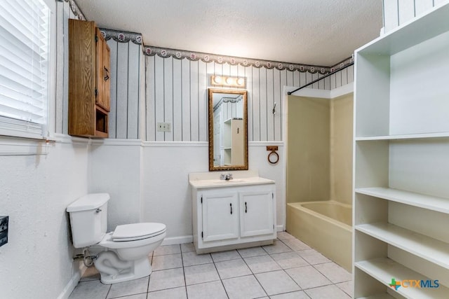 1488 Canyon Edge, Canyon Lake, TX 78133 - full bath with tile patterned floors, vanity, a textured ceiling, toilet, and shower / washtub combination